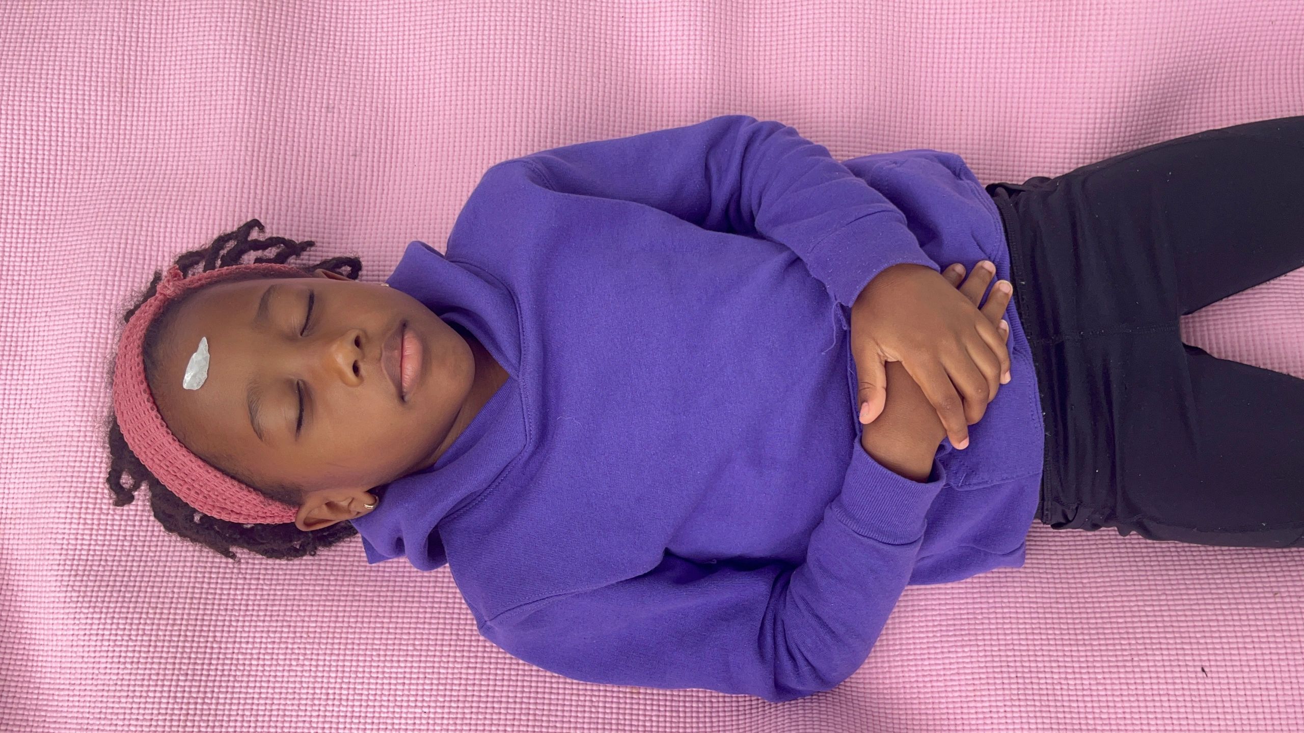 Eliahana (4), enjoying a breathing exercise at a free yoga event hosted by Heart of Hearts LLC 