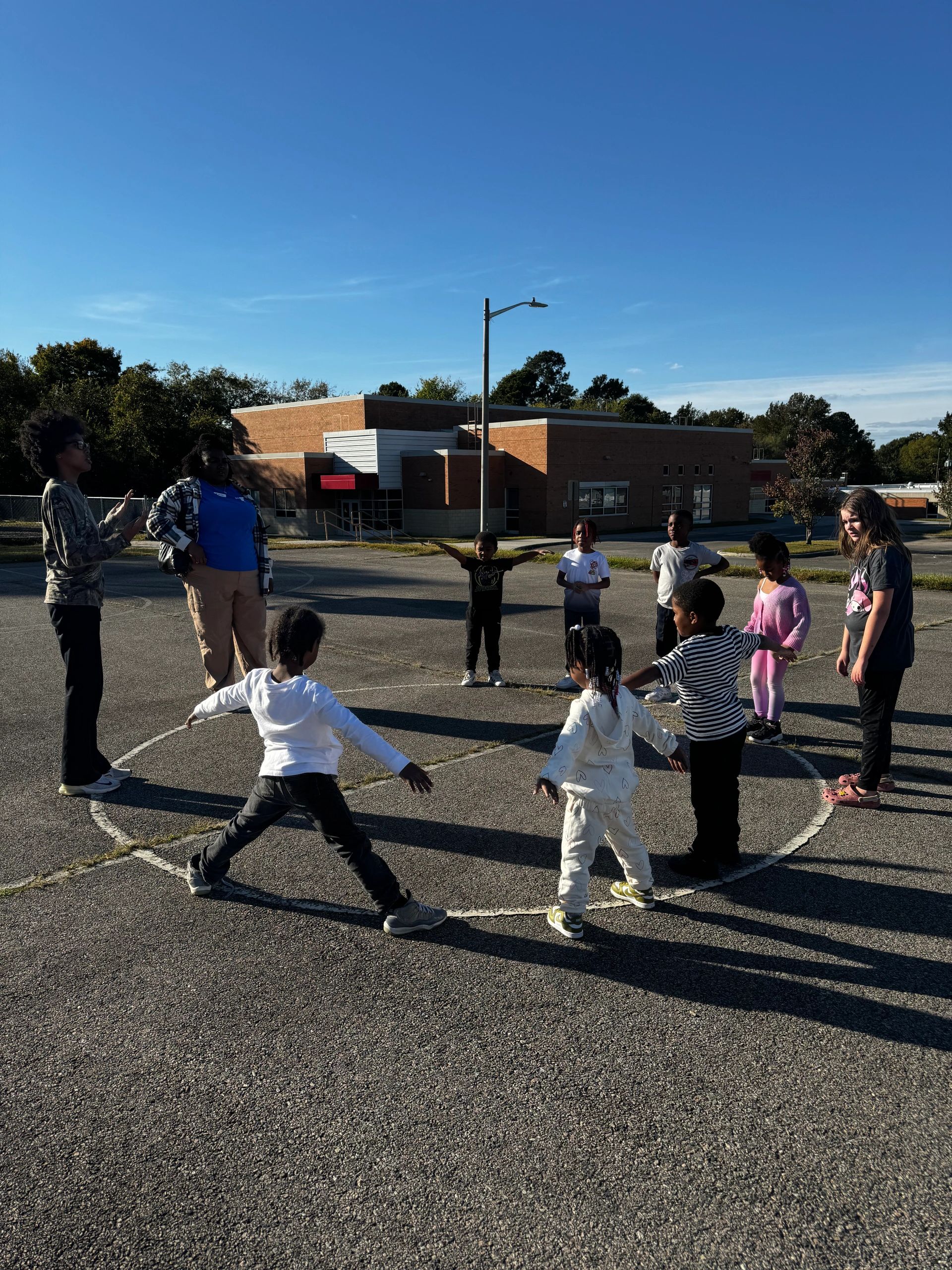 Local youth participating in physical activity, led by Salimah of G28